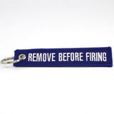 Remove Before Firing Keychain - Blue/White