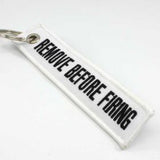 Remove Before Firing Keychain - White/Black